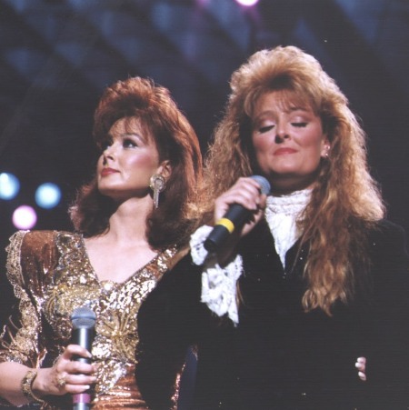 Wynonna Judd with her mother Naomi Judd at some concert.
